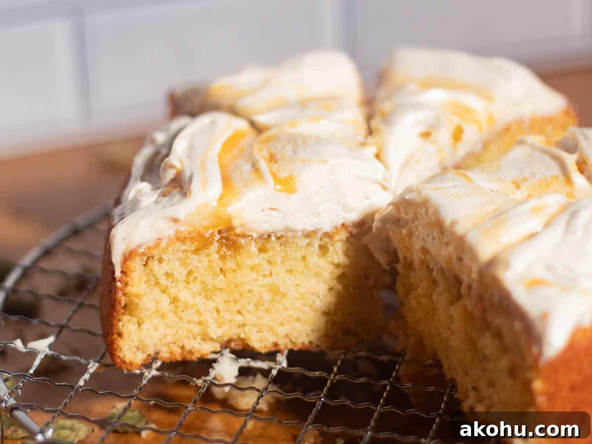 Brown butter cream cheese frosting spread on cake slices with smooth creamy texture and visible brown butter speckles.