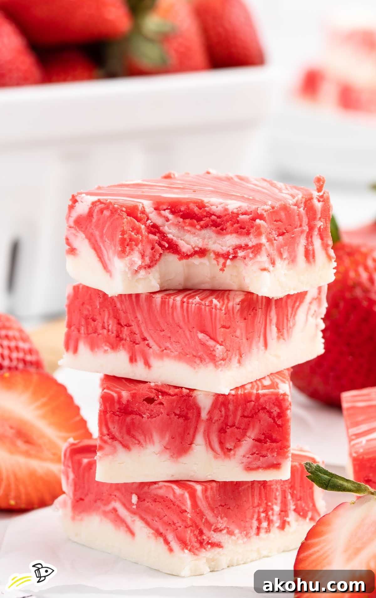 a close up shot of Strawberry Fudge stacked on top of each other with one having a bite taken out of it