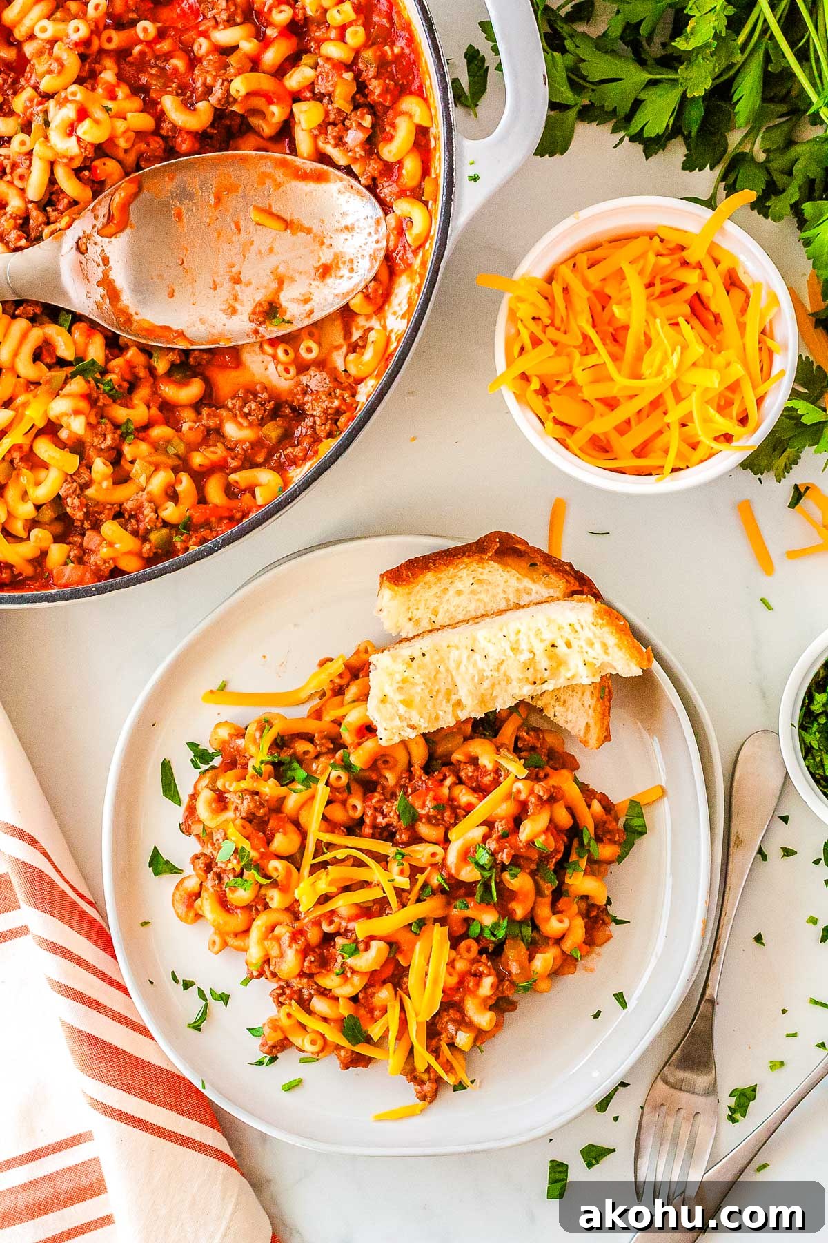 Sloopy Joes Pasta on a plate with a who pan of it in the background. 