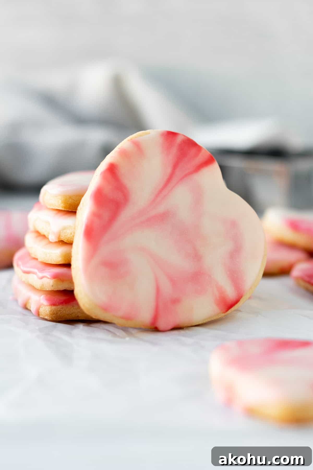 stack of heart shaped marbled sugar cookies with one cookie leaning against the stack
