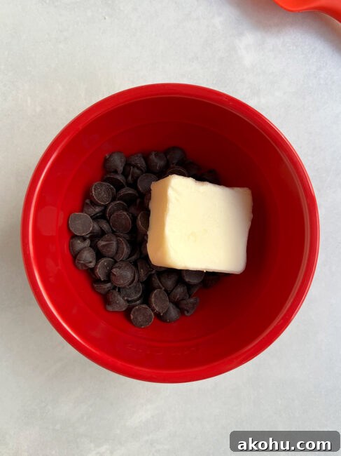Chocolate and butter in a red bowl to make the filling for the individual key lime pie bites.