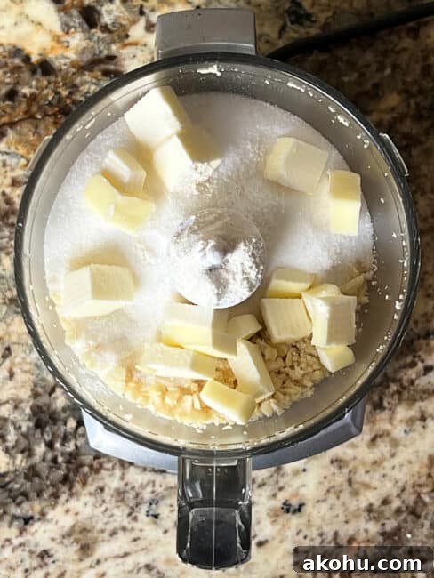 Salt, sugar, flour and butter added to macadamia nuts in the food processor.