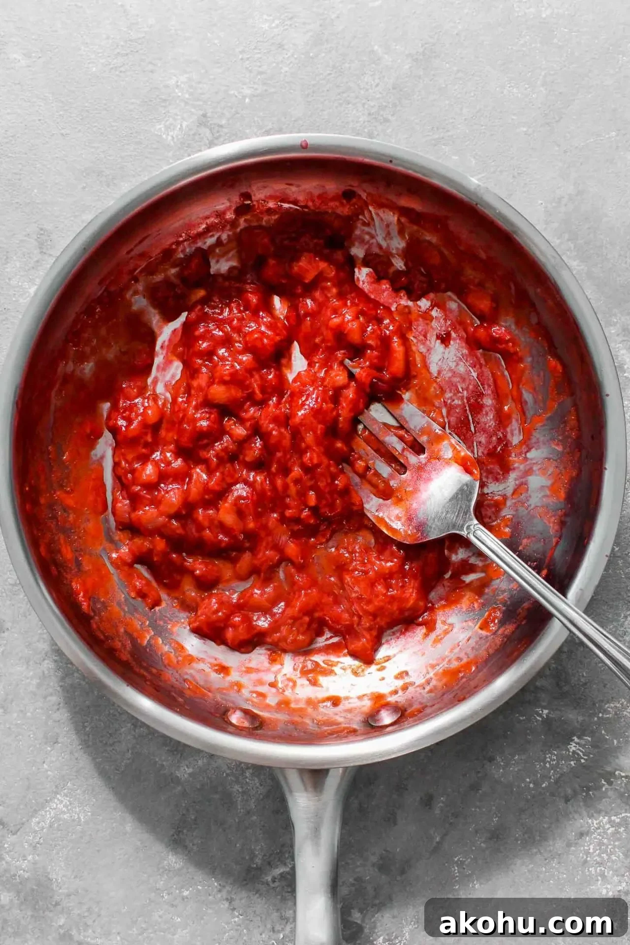 strawberry sheet cake frosting cooked strawberry paste in skillet