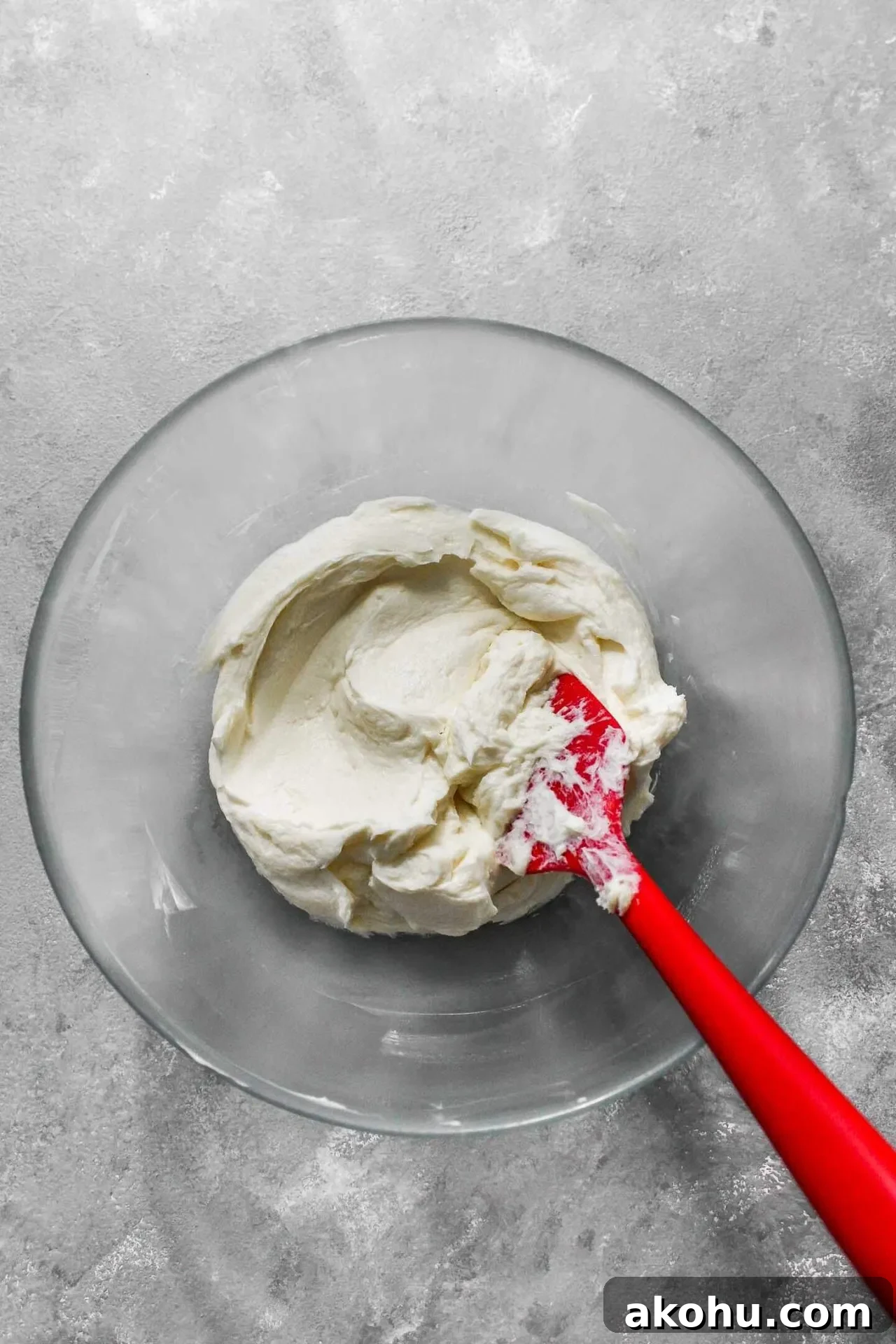 strawberry sheet cake frosting cheesecake and butter mixed together in bowl