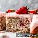 sliced strawberry sheet cake on parchment lined wire rack decorated with fresh strawberries and blueberries (6)
