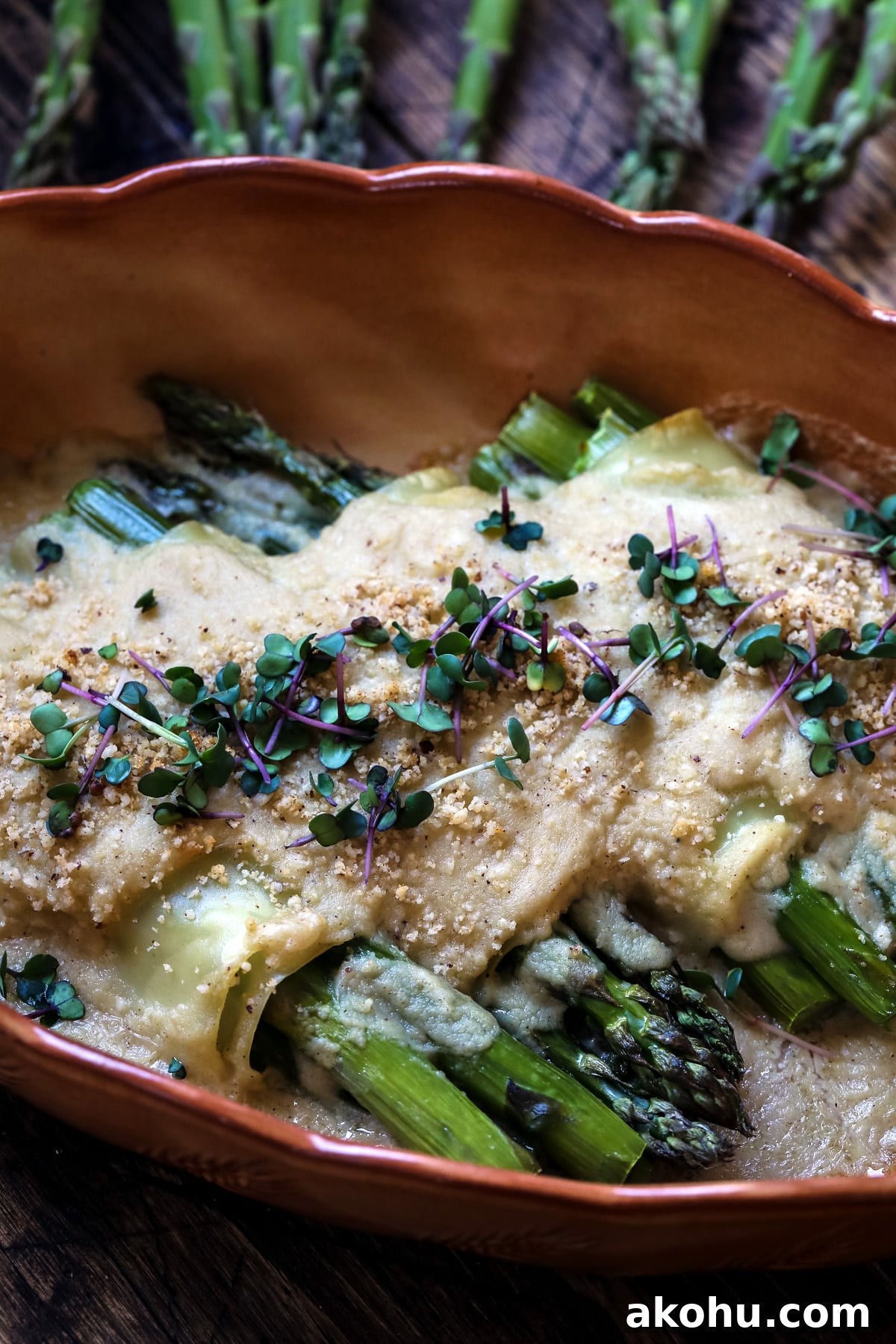 Vegan cannelloni with asparagus in a baking dish.