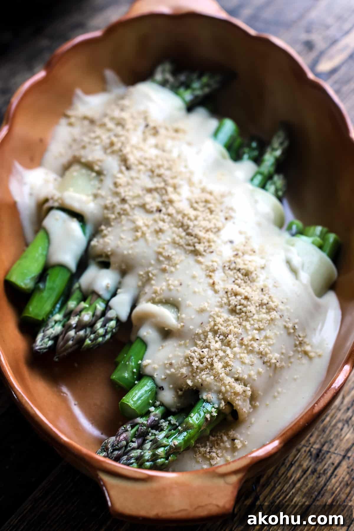 Vegan asparagus cannelloni with vegan bechamel and parmesan.