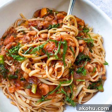 image white bean and kale linguine in a white bowl.