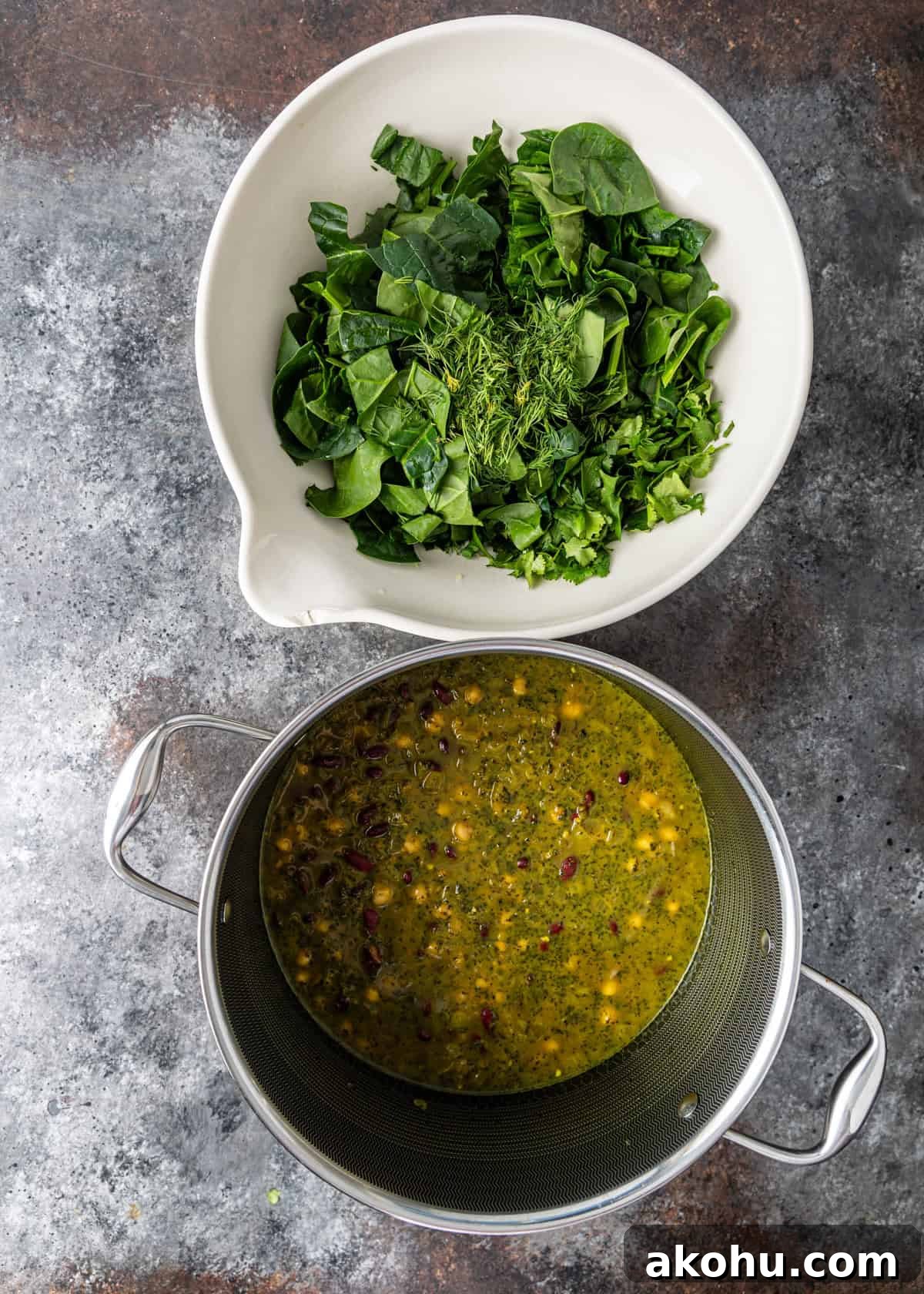 overhead: iranian noodle soup with chopped fresh herbs ready to be added to the side