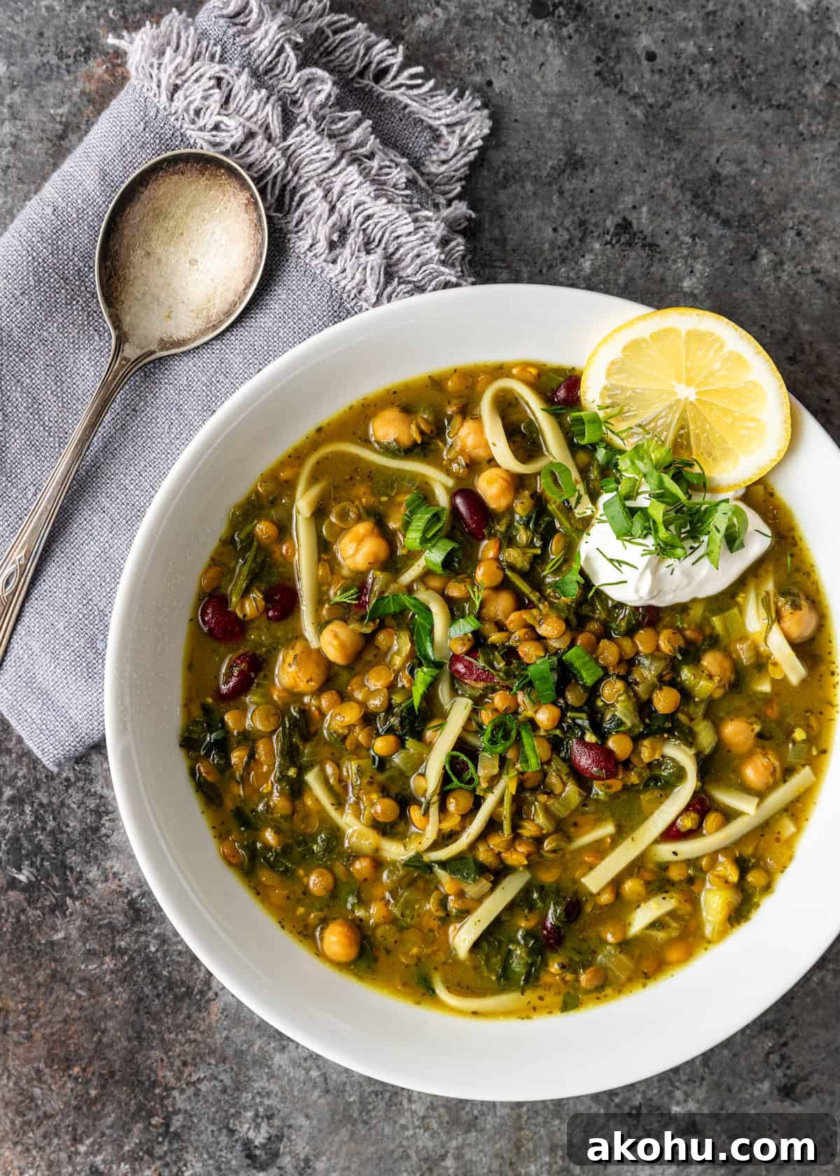 overhead: a bowl of persian noodle soup with garnishes on top