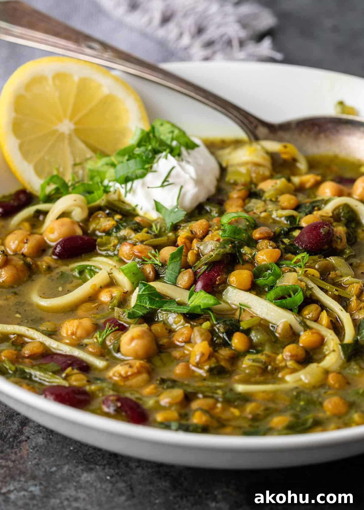 closeup: iranian noodle soup with noodles, beans, and fresh herbs