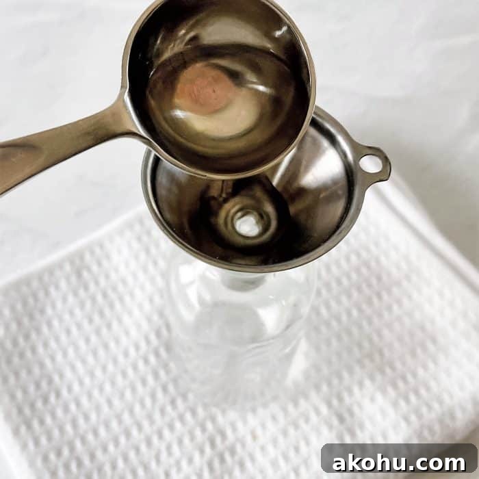 adding 2 tablespoons witch hazel to 4 oz glass spray bottle