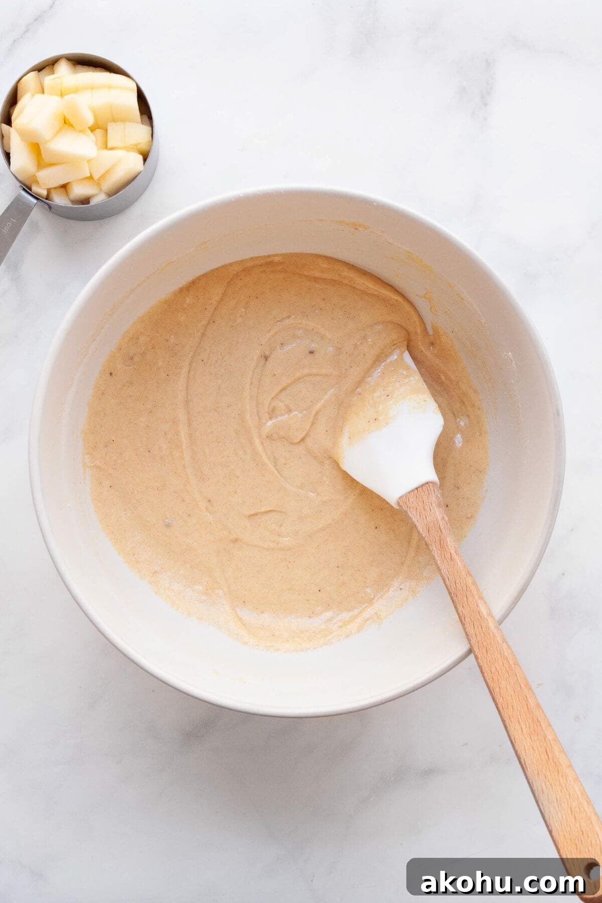 Gluten-Free Apple Cake: Moist Recipe with Cinnamon Crumble 5 Gluten-free apple cake batter in a mixing bowl.