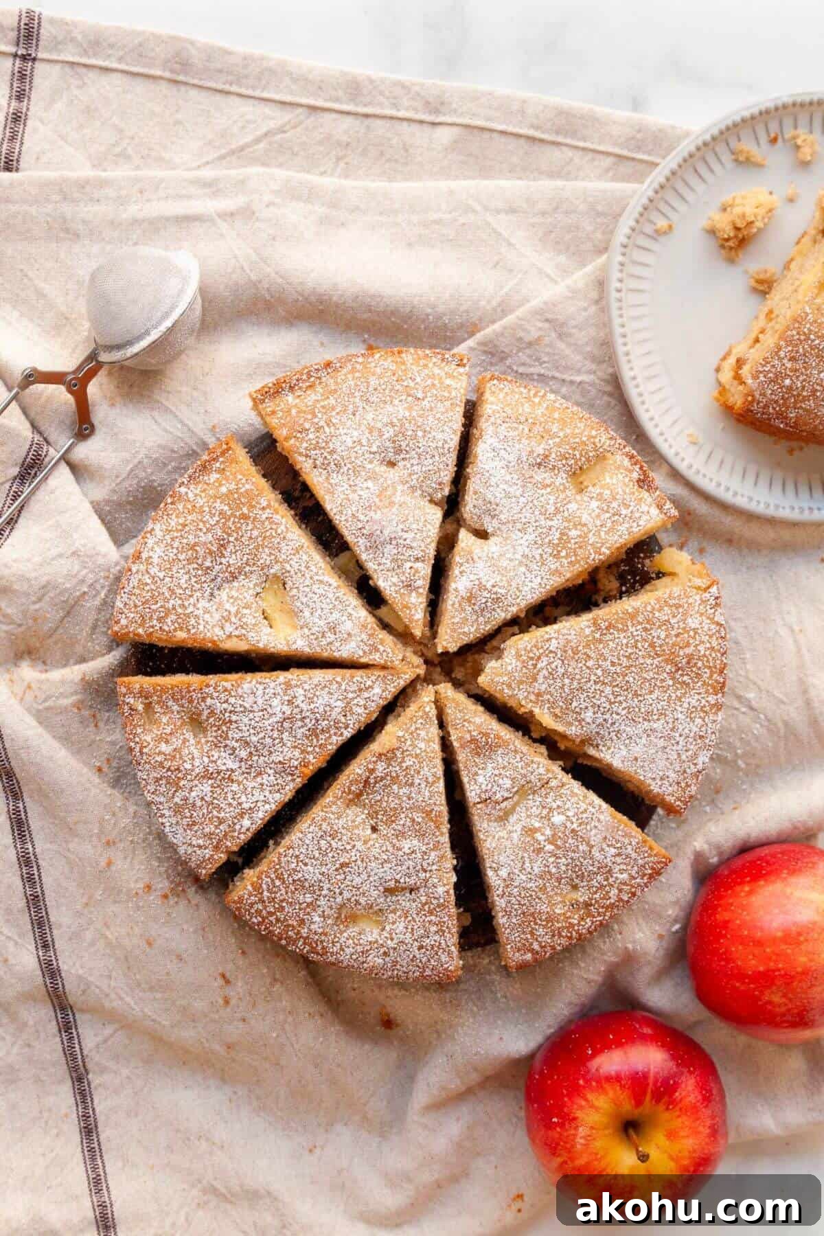 Gluten-Free Apple Cake: Moist Recipe with Cinnamon Crumble 9 Cooled and sliced gluten-free apple cake dusted with powdered sugar on top.