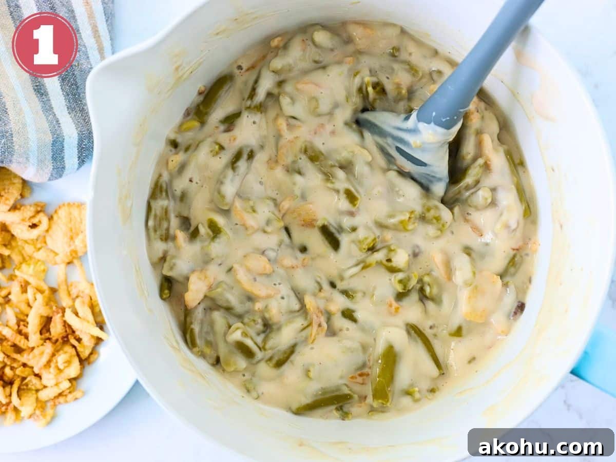 Cream of mushroom soup, green beans and fried onions in a bowl.