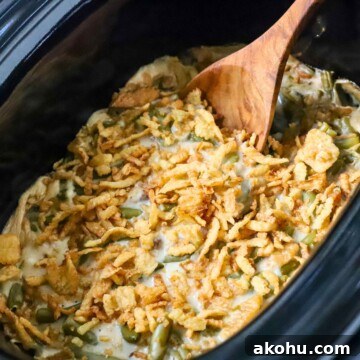 A crock pot green bean casserole freshly cooked.