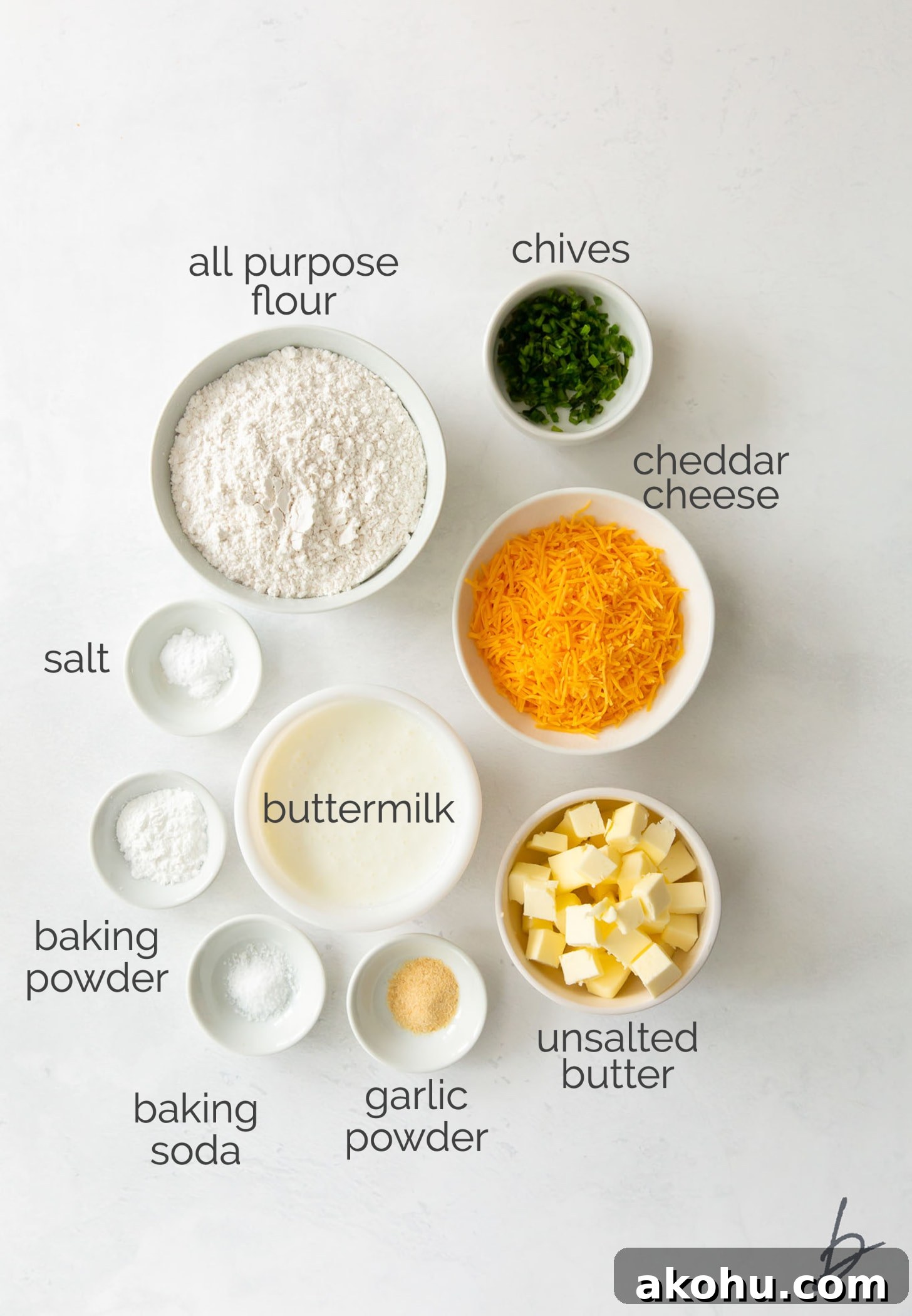 cheddar biscuit ingredients in bowls labeled with text