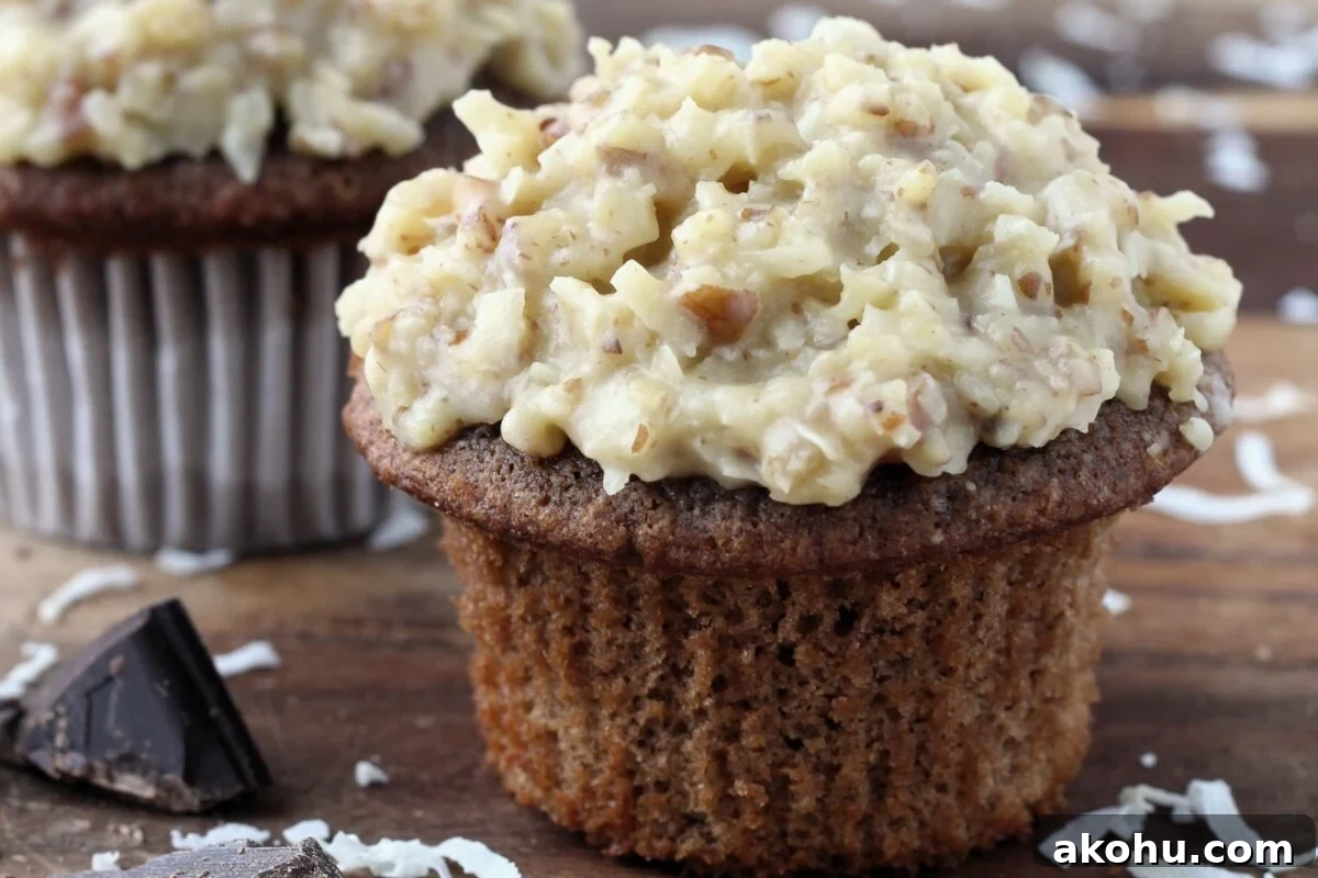 Decadent German Chocolate Cupcakes with Coconut-Pecan Frosting 4 Fully decorated German chocolate cupcakes topped generously with coconut pecan frosting.