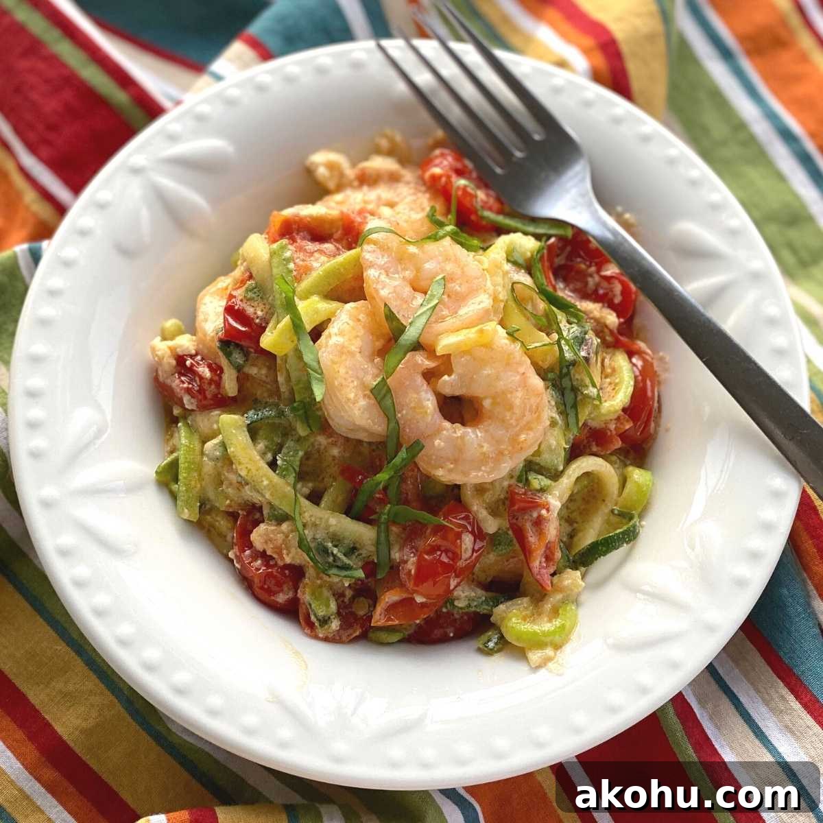 Viral Tik Tok Baked Feta Zoodles and Shrimp in a bowl with a fork.