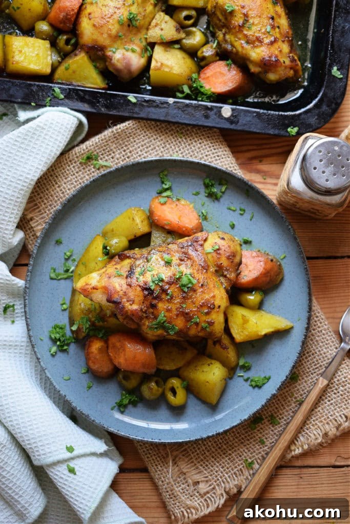 Moroccan chicken dinner on blue plate with a napkin and a fork.