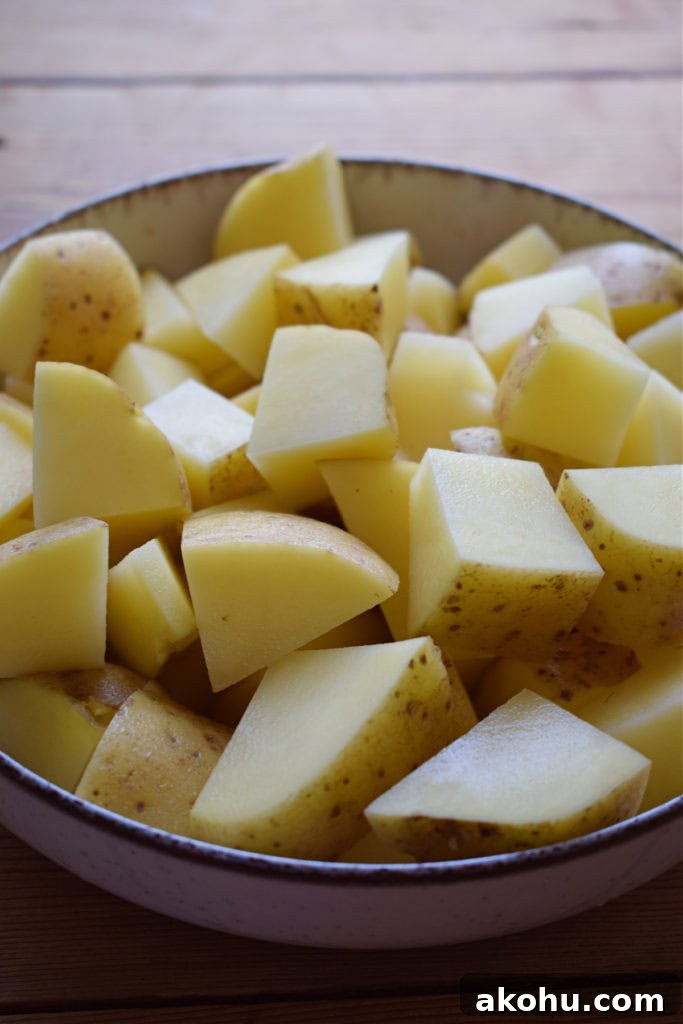 Cut and washed potatoes in a bowl.