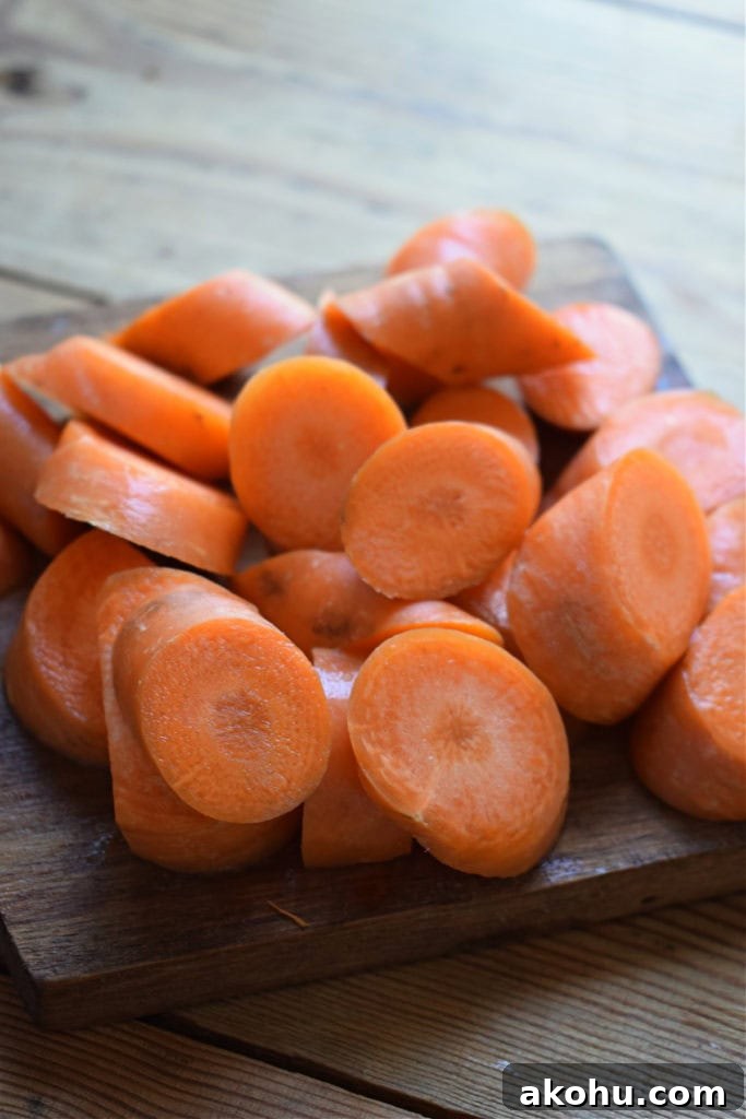 Cut carrots on a cutting board.