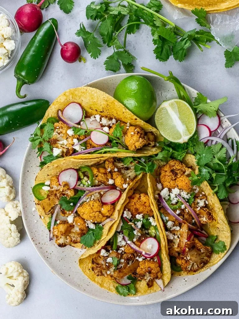 Chipotle Roasted Cauliflower Tacos with Smoky Lime Slaw 4 roasted chipotle cauliflower tacos with lime, radish, jalapenos in corn tortillas