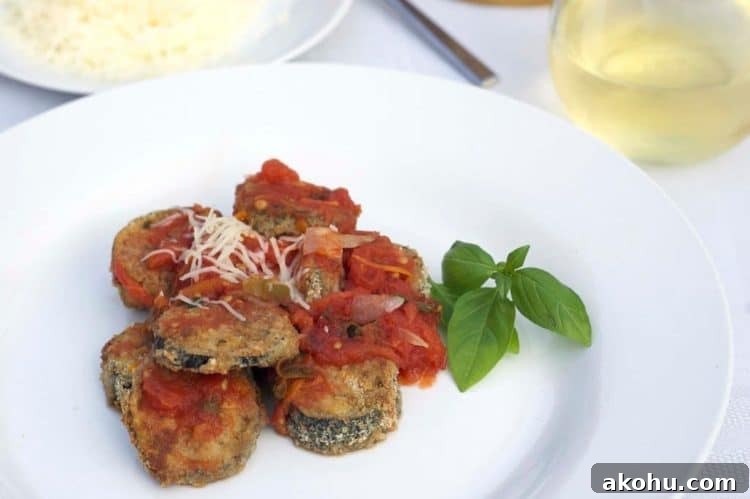 Baked Eggplant in Fresh Basil Marinara Sauce 2 A plate of food on a table, with Eggplant and basil