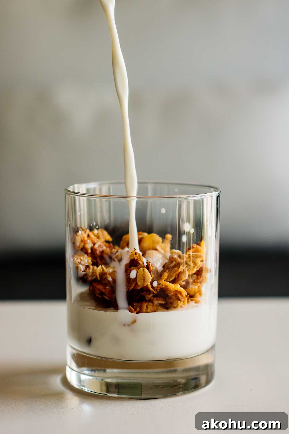 Crunchy Cornflake Granola Cereal Recipe for Breakfast 3 milk pouring over a glass with granola