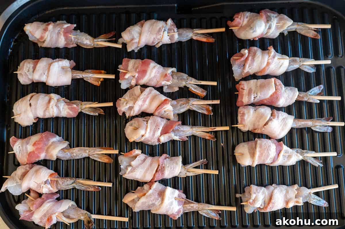 raw bacon-wrapped shrimp on a Ninja Grill.