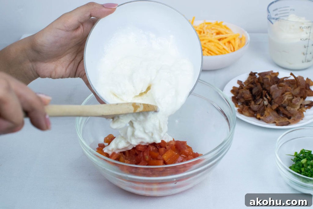 Adding mayonnaise to tomatoes for BLT dip