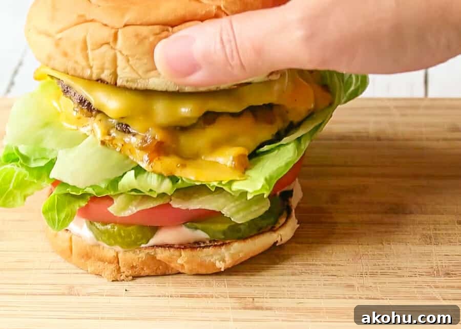 assembling the layers of the In-N-Out Copycat Double-Double Animal-Style Burger