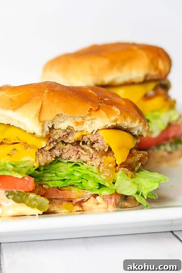 bite shot of an IIn-N-Out Copycat Double-Double Animal-Style Burger
