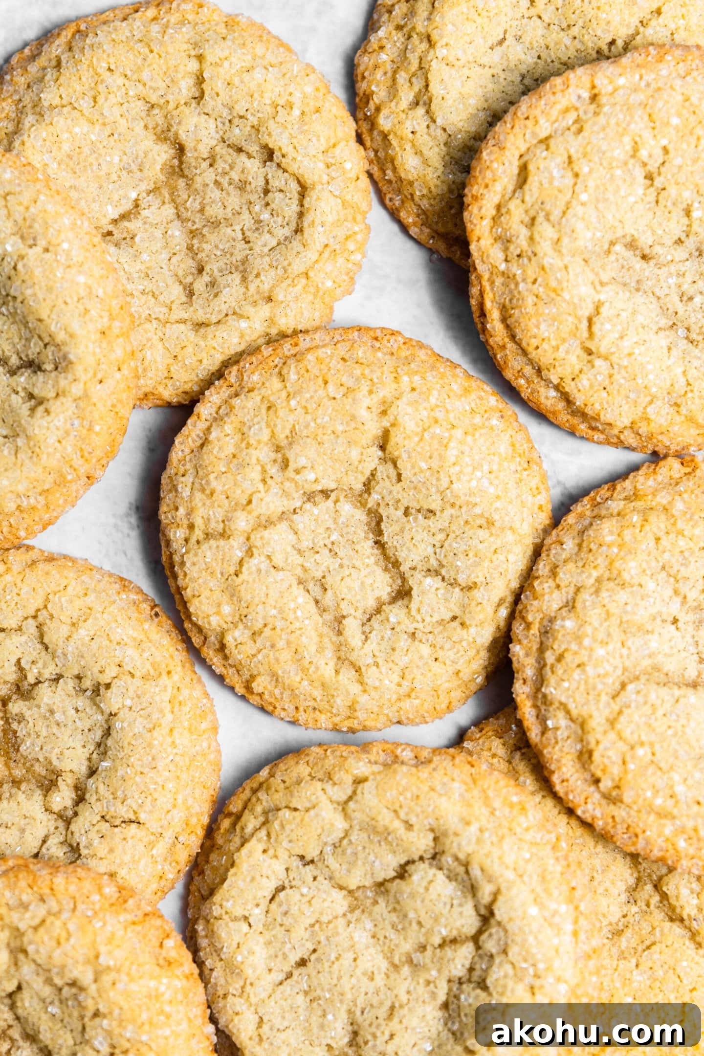 Drop-Style Vanilla Sugar Cookies: Quick Classic Recipe 9 Freshly baked drop style sugar cookies spread on a marble countertop.