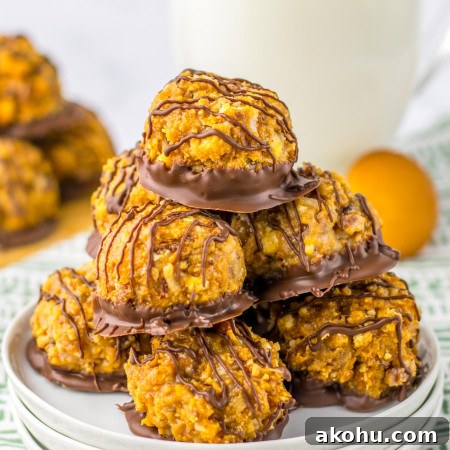 Stacked Samoas truffles on a white plate, with a glass of milk in the background