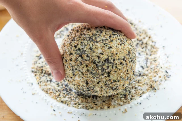 Everything Bagel Cheese Ball Recipe for Parties and Snacks 11 Rolling the Cheese Ball in Everything Bagel Seasoning