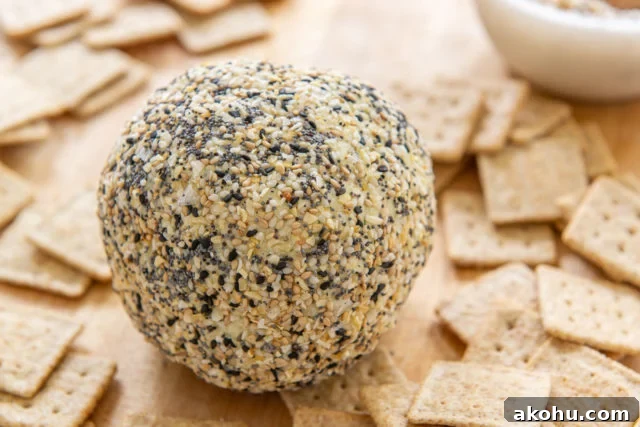 Everything Bagel Cheese Ball - With Crackers on Wooden Board