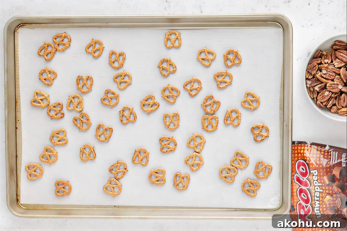 pretzels spread out on a lined baking sheet.