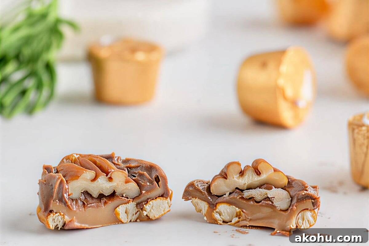 side view of a halved rolo pretzel turtle showing the caramel filling.
