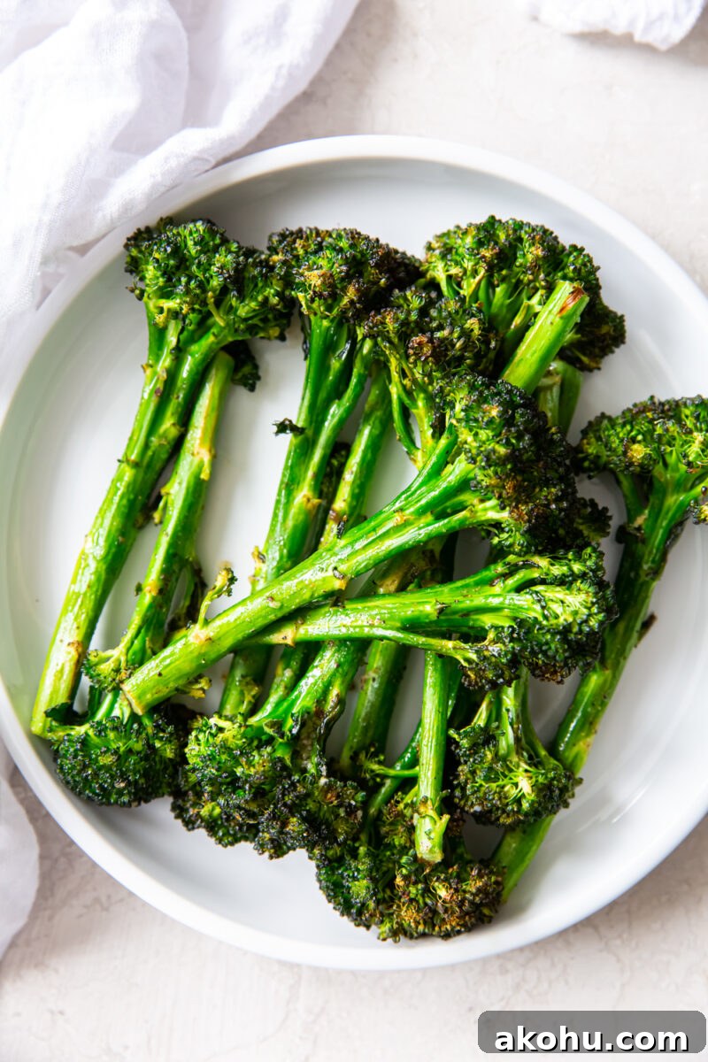 Crispy Air-Fryer Broccolini with Garlic and Lemon 2 air fryer broccolini on a white plate with a white napkin