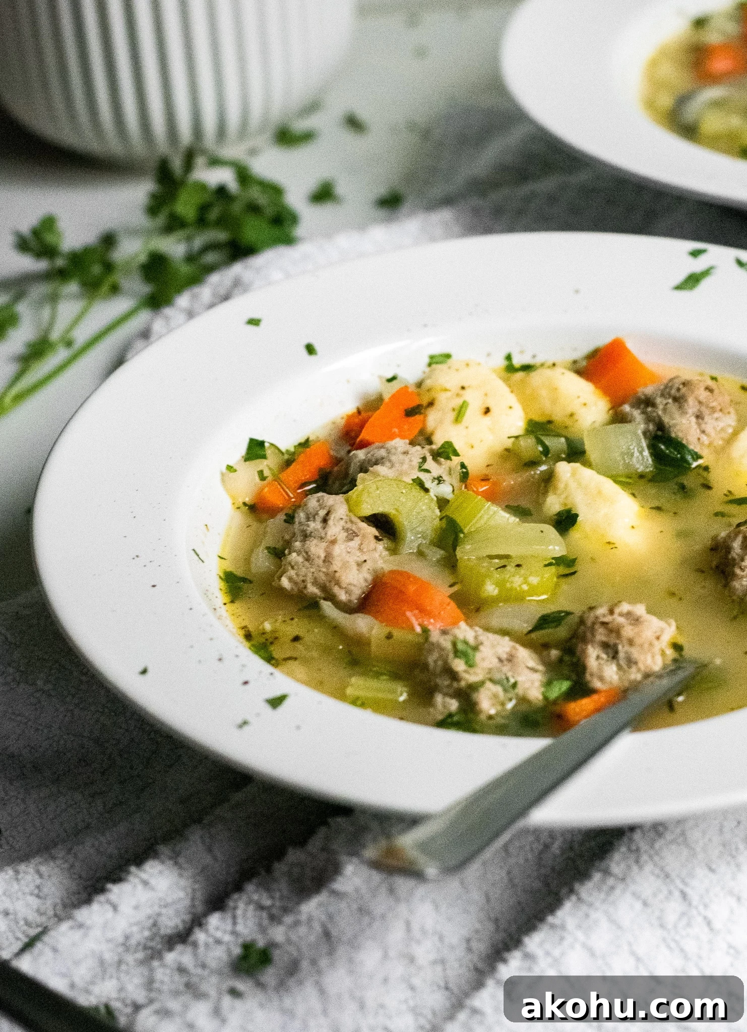 Meatball and dumpling soup in a bowl.