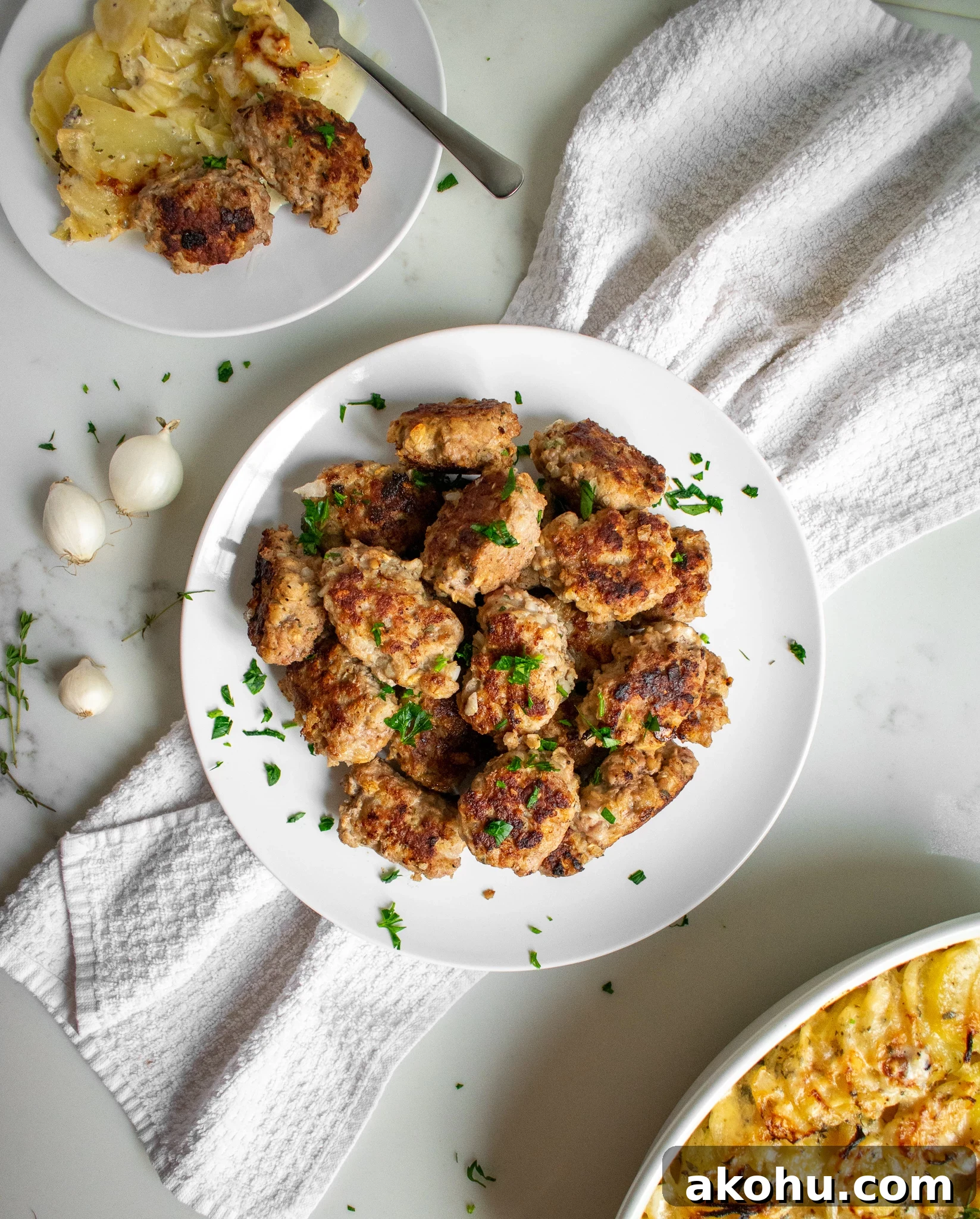 Danish meatballs on a plate with potatoes on the side.