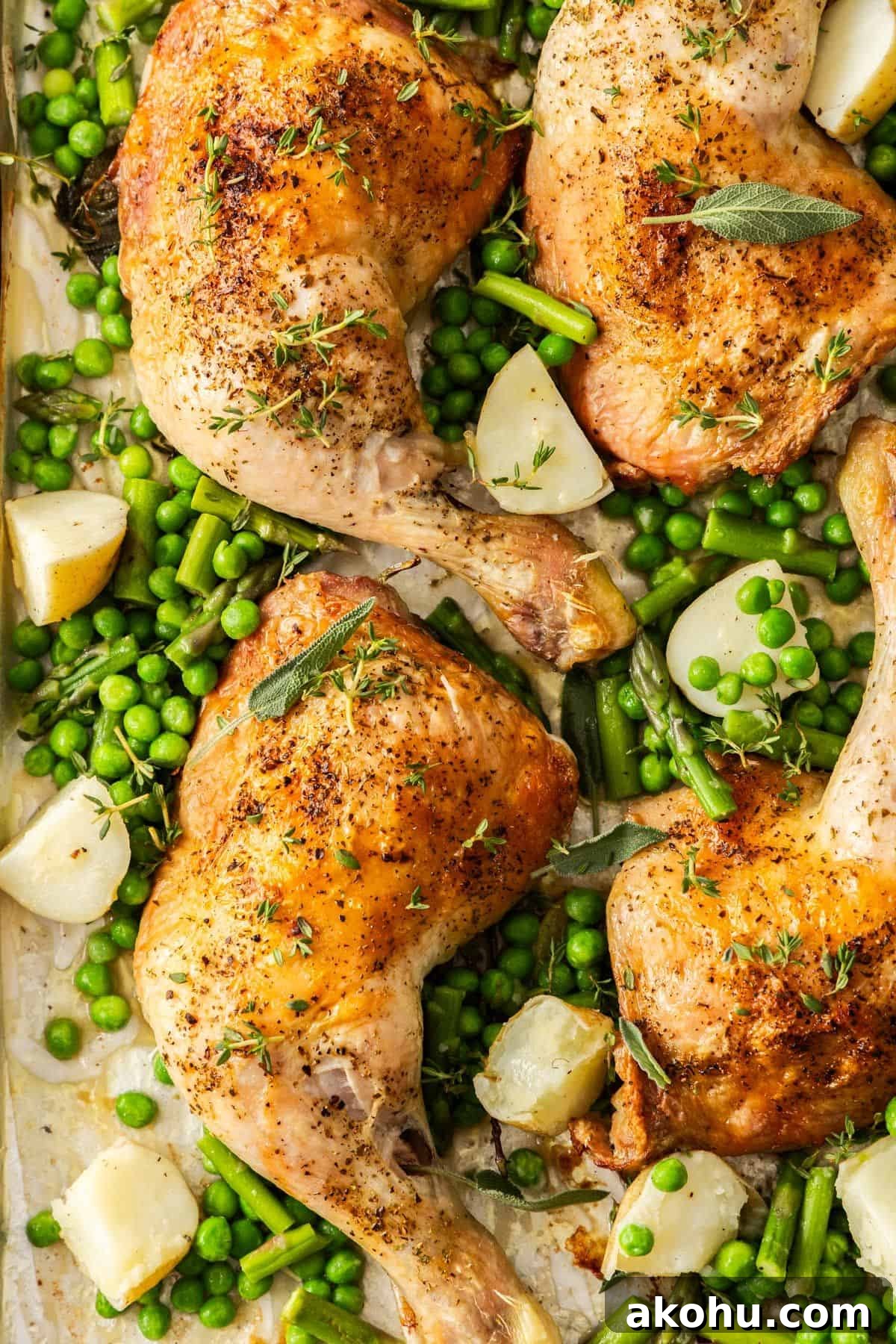 Easter Dinner Mains: Elegant Roast and Ham Recipes 12 Roasted Chicken Marylands on a baking tray, surrounded by some cubes of potatoes, peas and green beans.