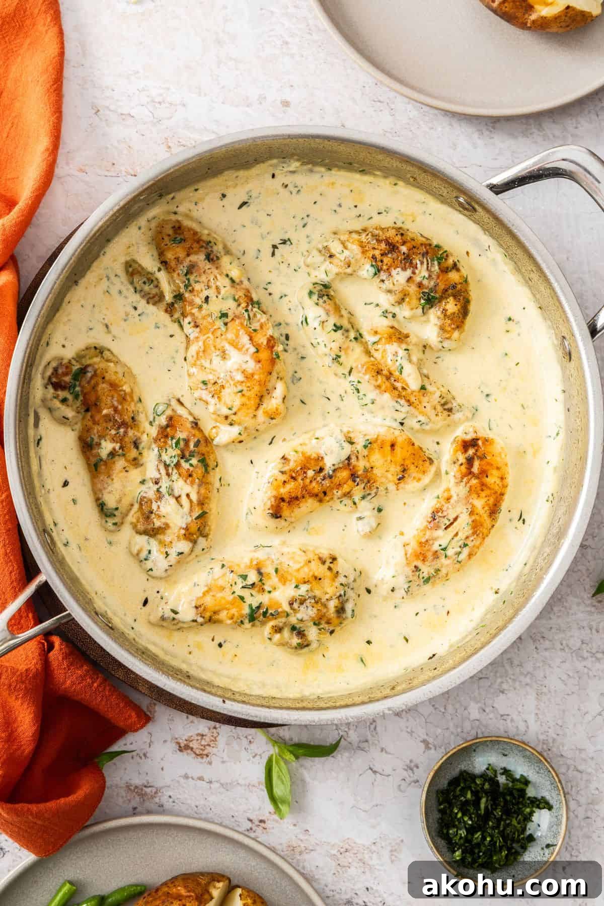 Easter Dinner Mains: Elegant Roast and Ham Recipes 20 Large frying pan with Creamy Herb Chicken, ready to serve.