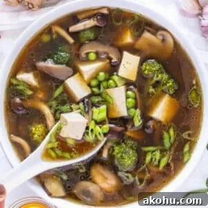 Easy one pot tofu soup with miso broth and fresh toppings on table.