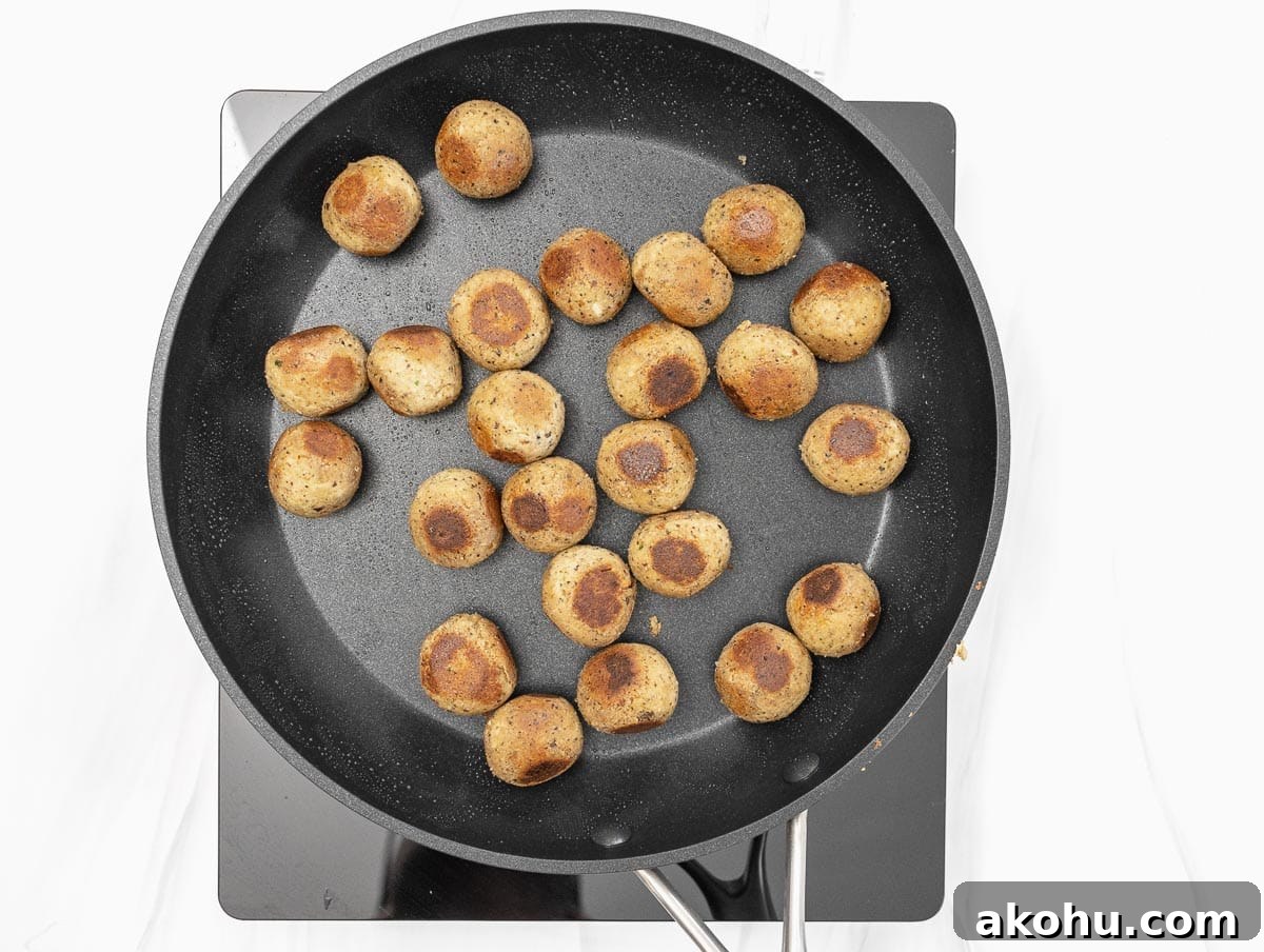 pan-frying the meatballs in a large non-stick skillet