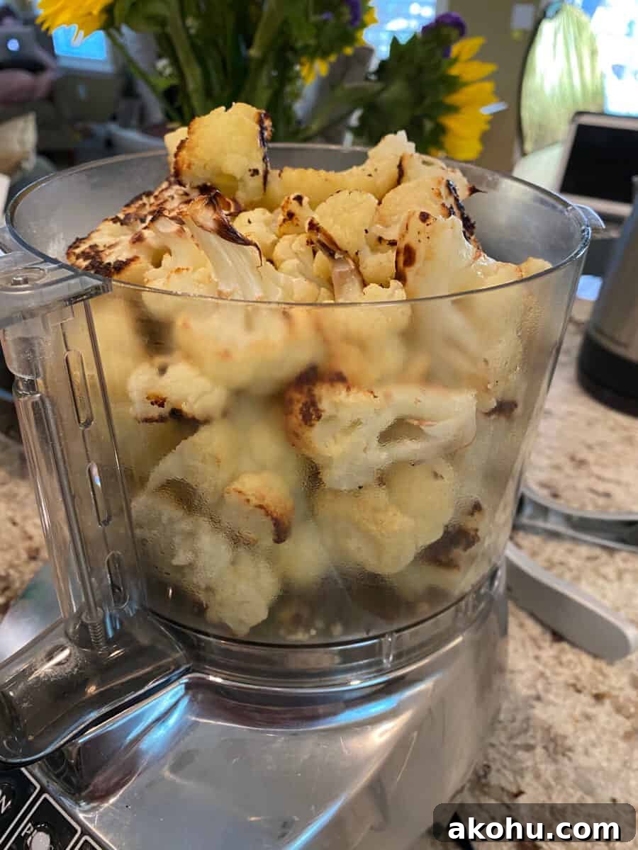 Cauliflower Hummus ingredients in the bowl of a food processor.