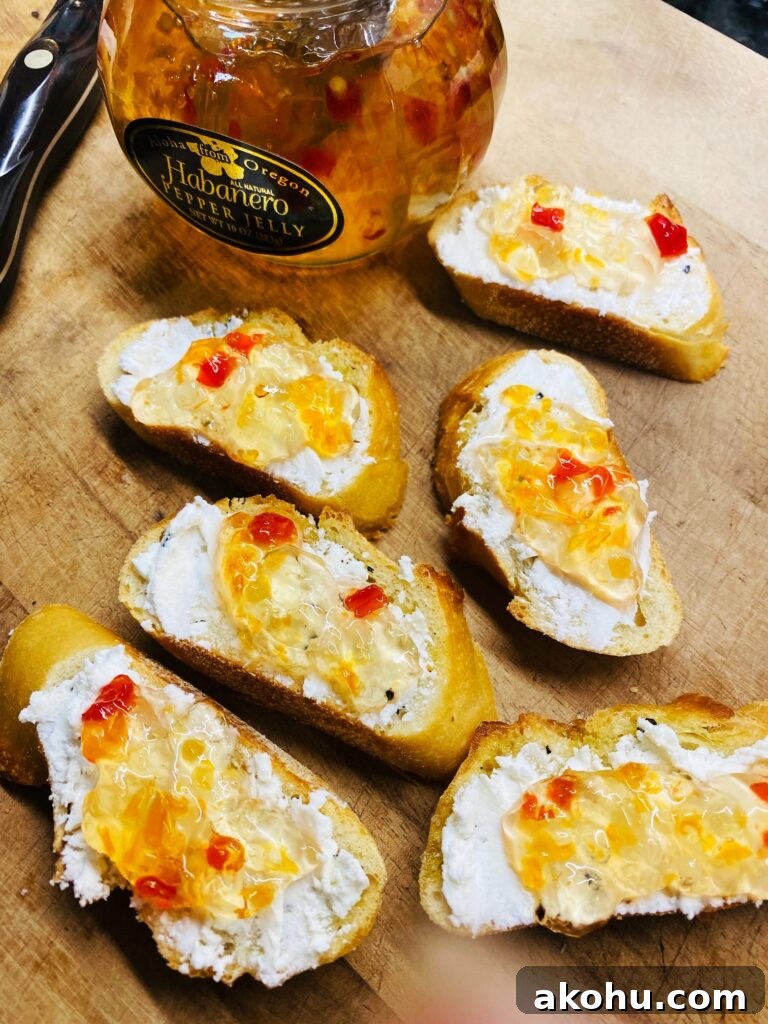 Spicy Pepper Jelly Goat Cheese Crostini Recipe 8 adding the pepper jelly to the bread