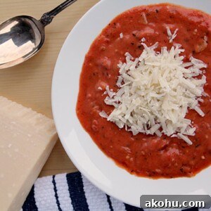 This Easy Tomato Soup Recipe is ready in under an hour! It's made with canned tomatoes, dried herbs, fresh onion, and cream—just add a grilled cheese!