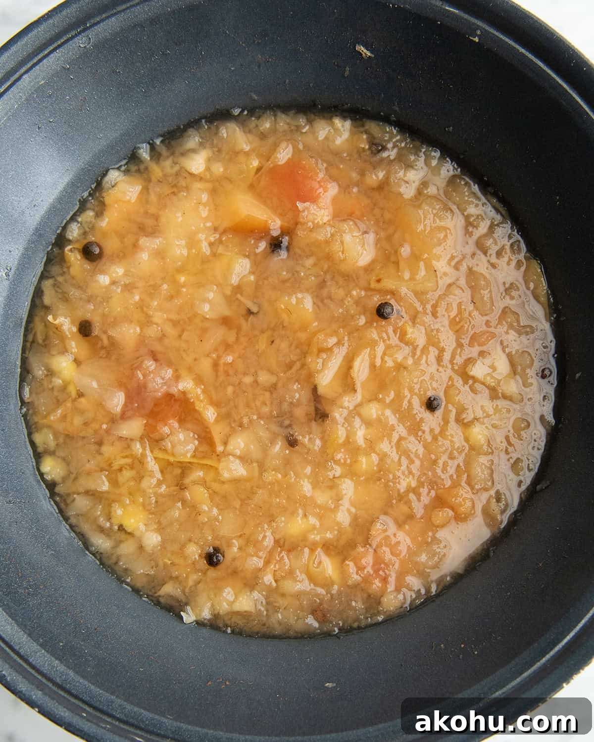how to make apple cider recipe - mashed apple cider mixture after cooking for 1 hour in a crock pot